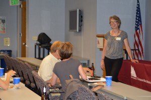 Smiling presenter addressing small meeting group