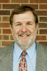 Smiling bearded man wearing suit and tie