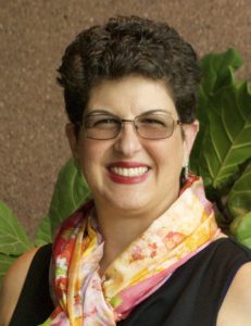 Smiling woman with glasses and colorful scarf